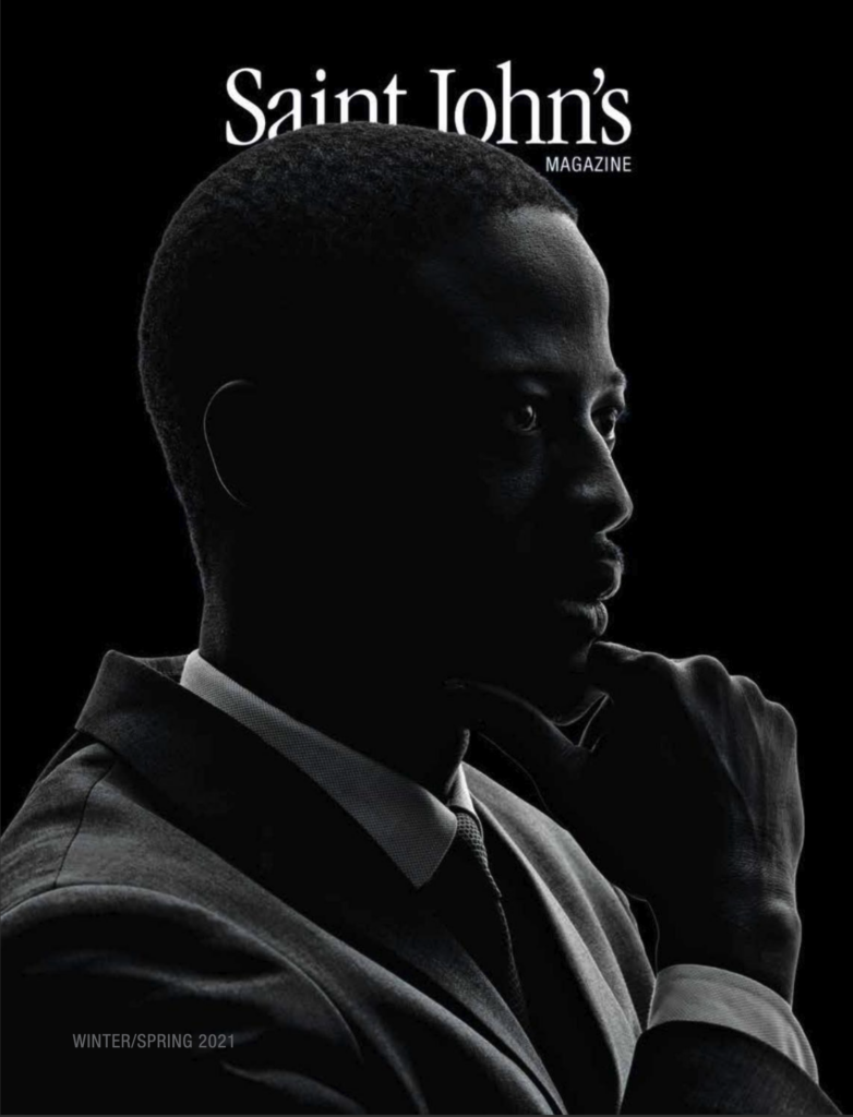 Silhouetted profile of a person in a suit and tie against a black background featured on the cover of Saint John's Magazine, Winter/Spring 2021 edition.
